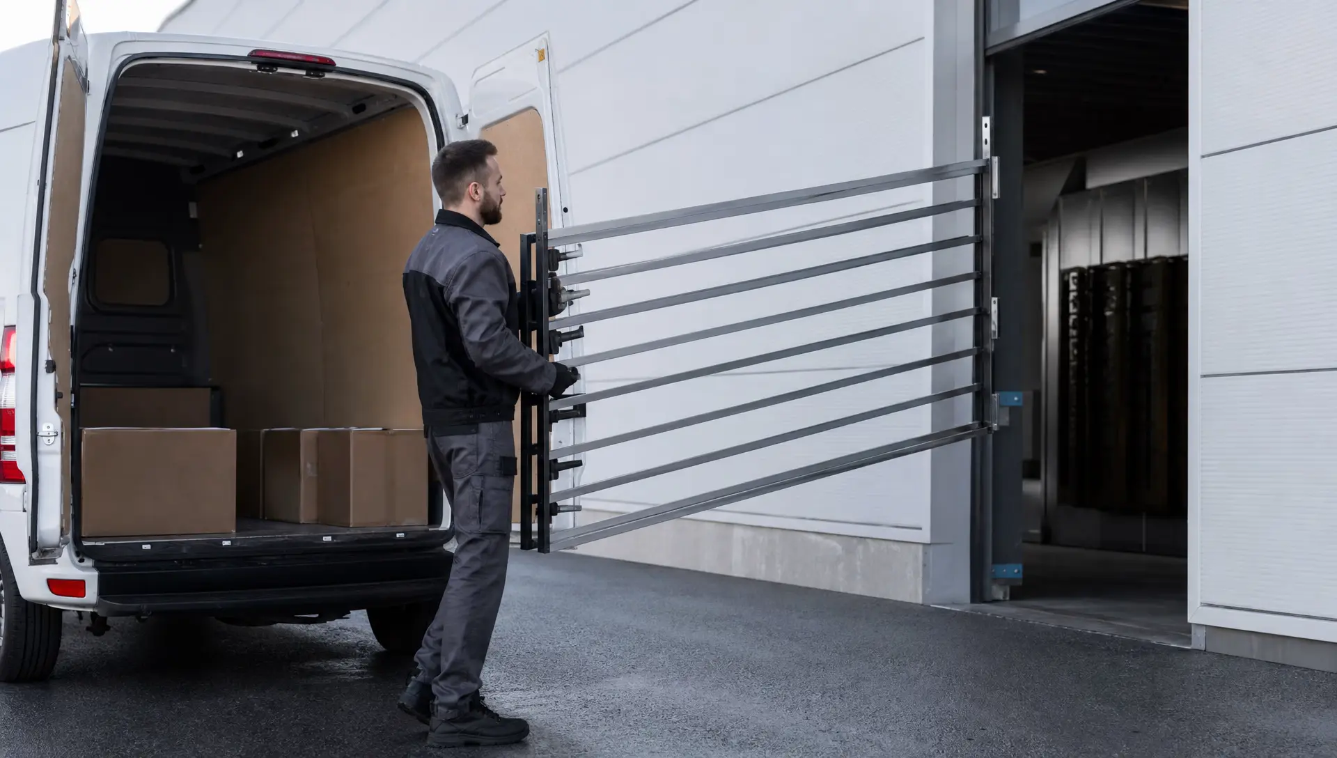 Coated railing sections being loaded into a van for local delivery