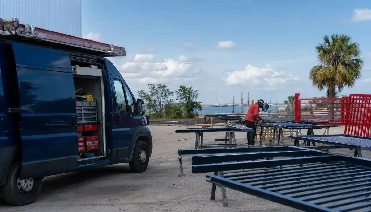 APC crew running an outdoor powder coating setup on the Gulf coast
